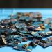 Pile of disassembled circuit boards on a blue surface. Perfect for tech themes.