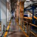 Wide view of a modern factory interior showcasing industrial machinery and conveyor systems.