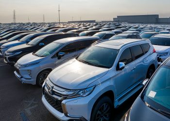 Modern prestige shiny cars in rows on asphalt parking of contemporary manufacture in daytime