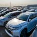 Modern prestige shiny cars in rows on asphalt parking of contemporary manufacture in daytime