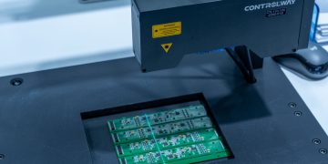 Close-up of a PCB inspection machine in action, highlighting technology.
