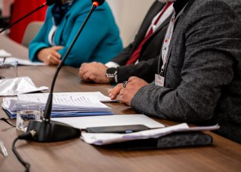 Close-up of professionals discussing documents at a business meeting in Ankara, Turkey.