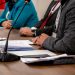 Close-up of professionals discussing documents at a business meeting in Ankara, Turkey.