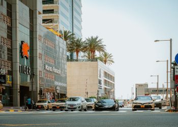 View of a busy street in Dubai's Marina District featuring modern architecture and vibrant traffic.