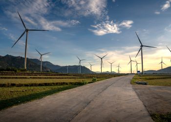 Scenic view of wind turbines in Vietnam countryside during sunset. Clean energy and sustainable landscape.