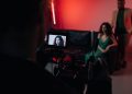 Behind the scenes of a studio filming session focused on actors within a creative setup.