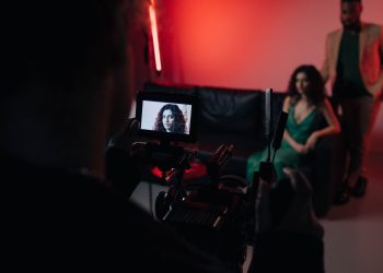 Behind the scenes of a studio filming session focused on actors within a creative setup.