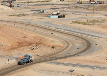 Drone shot of a developing construction site in Konza, Machakos County with dump trucks and dirt roads.