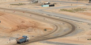 Drone shot of a developing construction site in Konza, Machakos County with dump trucks and dirt roads.
