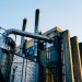 Low angle exterior of factory located on city street under blue sky in evening time