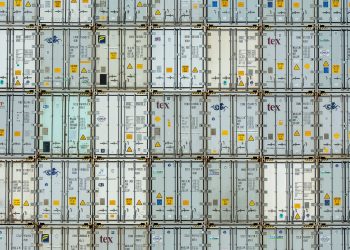 A patterned array of industrial shipping containers stacked in a storage terminal.