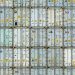 A patterned array of industrial shipping containers stacked in a storage terminal.