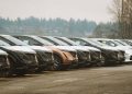 Rows of sleek electric cars parked outdoors, showcasing automotive design and innovation.