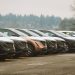 Rows of sleek electric cars parked outdoors, showcasing automotive design and innovation.