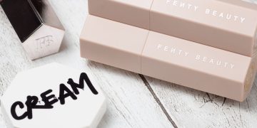 Stylish arrangement featuring beauty products on a wooden background, showcasing elegant packaging.