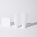 Minimalist white cosmetic containers with shadows, perfect for product mockups and ad designs.