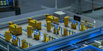 Detailed industrial model display showcasing machinery and systems indoors, emphasizing technology and design.