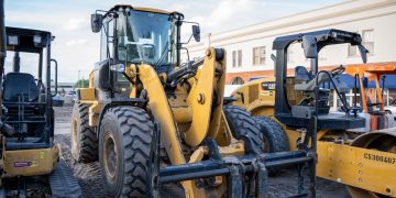 Front view of heavy construction machinery parked in an urban area.