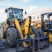 Front view of heavy construction machinery parked in an urban area.