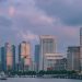 View of Shanghai's modern skyline at twilight with tall skyscrapers and vibrant clouds.
