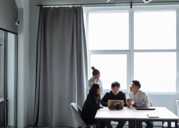 Group of diverse professionals collaborating in a modern office setting.