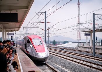 A sleek high-speed train arriving at Padalarang Station, offering modern transportation in Indonesia.