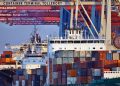 Container ships docked at Tollerort Terminal, Hamburg during sunset.