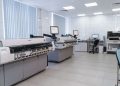 Spacious laboratory interior featuring state-of-the-art machines and computers for research purposes.