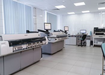Spacious laboratory interior featuring state-of-the-art machines and computers for research purposes.