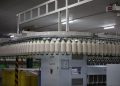 Industrial textile factory with yarn production line showcasing automated machinery for efficient manufacturing.