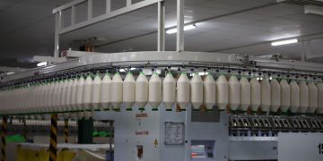 Industrial textile factory with yarn production line showcasing automated machinery for efficient manufacturing.