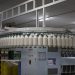 Industrial textile factory with yarn production line showcasing automated machinery for efficient manufacturing.
