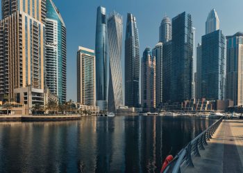 Explore the towering skyscrapers of Dubai Marina reflecting beautifully on the water.