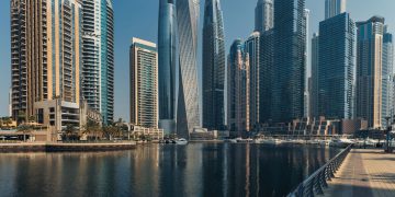 Explore the towering skyscrapers of Dubai Marina reflecting beautifully on the water.