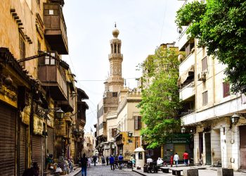 Explore the charm of a bustling historic street in Cairo with stunning architecture and cultural vibrancy.