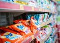 Vibrant selection of laundry detergents on a supermarket shelf, showcasing brands and variety.
