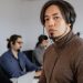 Focused call center team working attentively with headsets on in office.