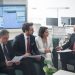 Group of business professionals discussing financial strategies in a modern office setting.