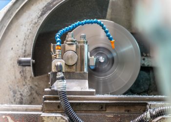 Close-up of a spinning lathe machine in an industrial workshop setting.