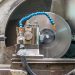 Close-up of a spinning lathe machine in an industrial workshop setting.