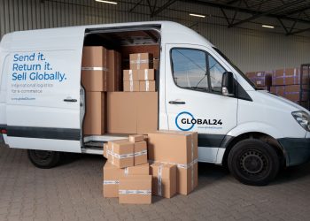 Delivery van loaded with cardboard boxes for global shipping logistics.