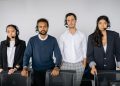 A diverse team of customer service agents wearing headsets, ready to assist.