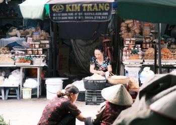 A vibrant market scene in Southeast Asia featuring vendors and local produce.