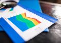 Close-up of a colorful business chart placed on a table with documents highlighting trends.