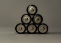 Metallic AA batteries stacked in a pyramid shape, symbolizing power and energy storage.
