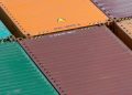 Aerial view of vibrant cargo containers arranged in a pattern, emphasizing logistics and transportation.