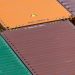 Aerial view of vibrant cargo containers arranged in a pattern, emphasizing logistics and transportation.