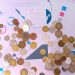 Image of various coins on financial documents with graphs and charts.