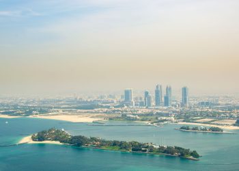 Stunning aerial view of Dubai's skyline with artificial islands and turquoise waters.