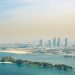 Stunning aerial view of Dubai's skyline with artificial islands and turquoise waters.